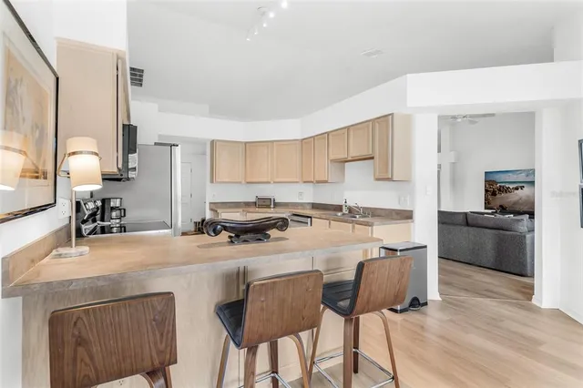 a kitchen with stainless steel appliances granite countertop a stove a sink dishwasher and a refrigerator