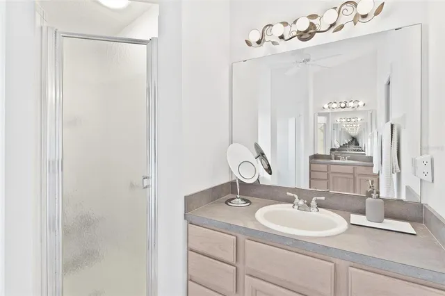 a bathroom with a tub sink and mirror