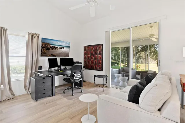 a living room with furniture and a floor to ceiling window