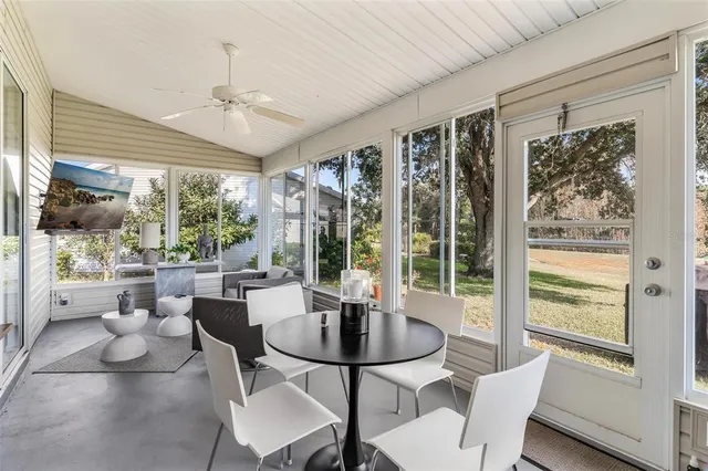 a front view of a house with a garden and trees