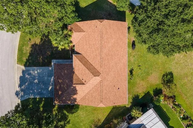 an aerial view of residential houses with yard and lake view