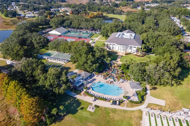 an aerial view of residential houses with outdoor space and swimming pool