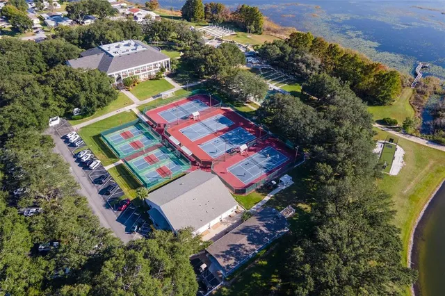 an aerial view of residential houses with outdoor space and lake view