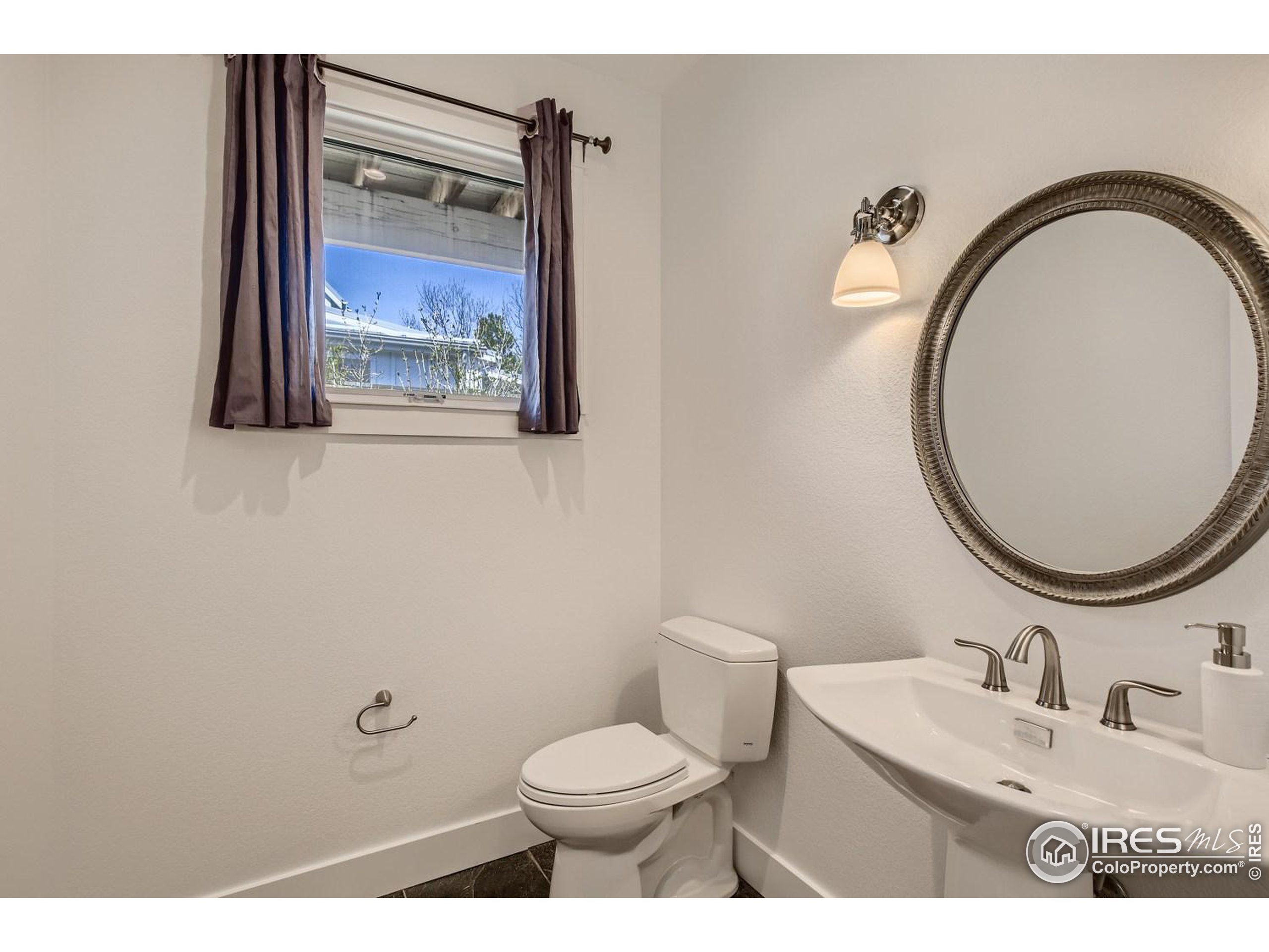1525 Oak Avenue Boulder, CO 80304 - Photo 12 of 30 a bathroom with a toilet a sink and mirror