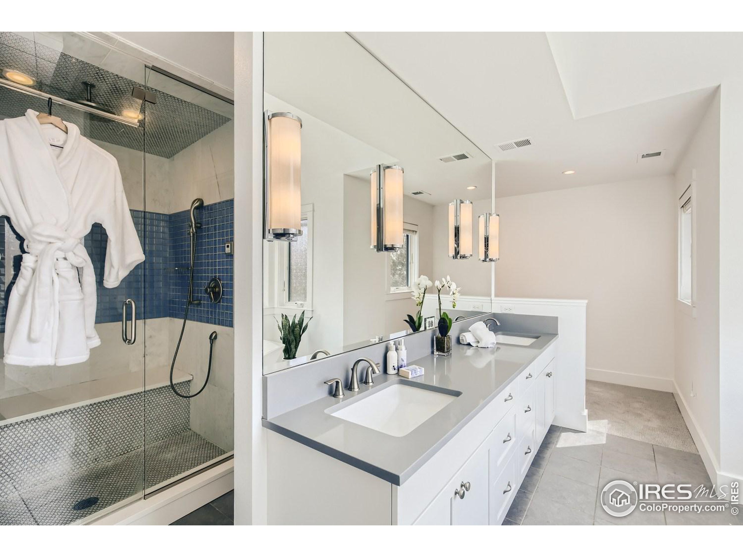 1525 Oak Avenue Boulder, CO 80304 - Photo 19 of 30 a bathroom with a sink mirror and a shower