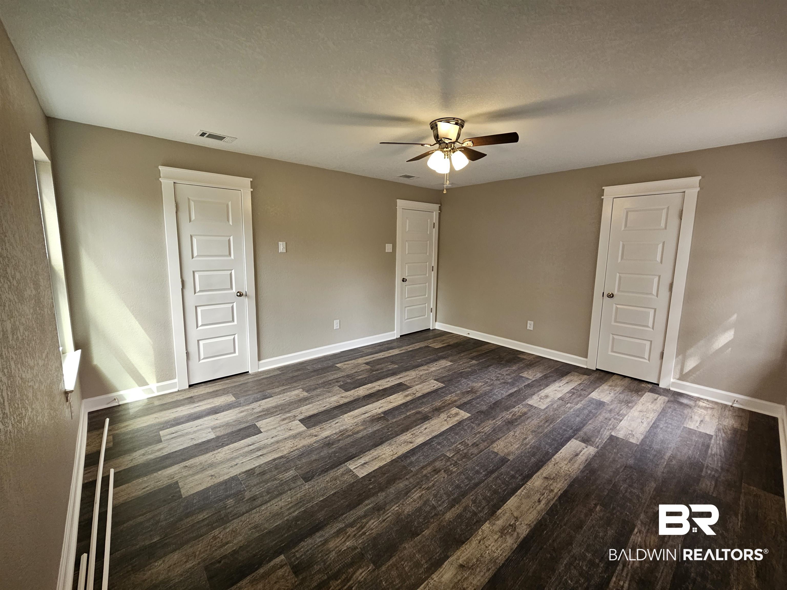 138 Wicker Way Daphne, AL 36526 - Photo 15 of 32 Unfurnished bedroom with dark wood-style flooring, ceiling fan, and a textured ceiling