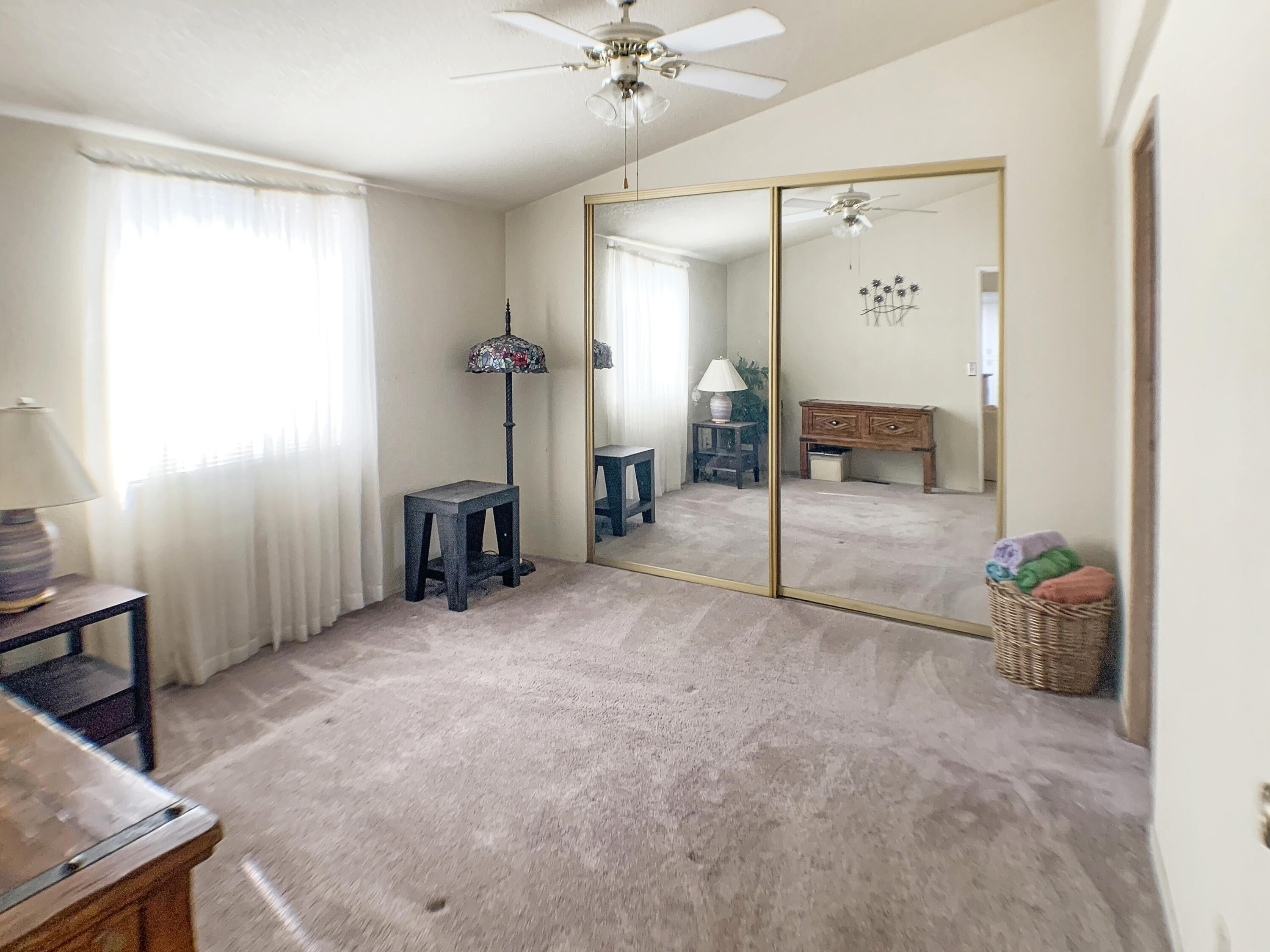 47685 Prado Way Indio, CA 92201 - Photo 12 of 26 a view of a livingroom with a staircase and a flat screen tv