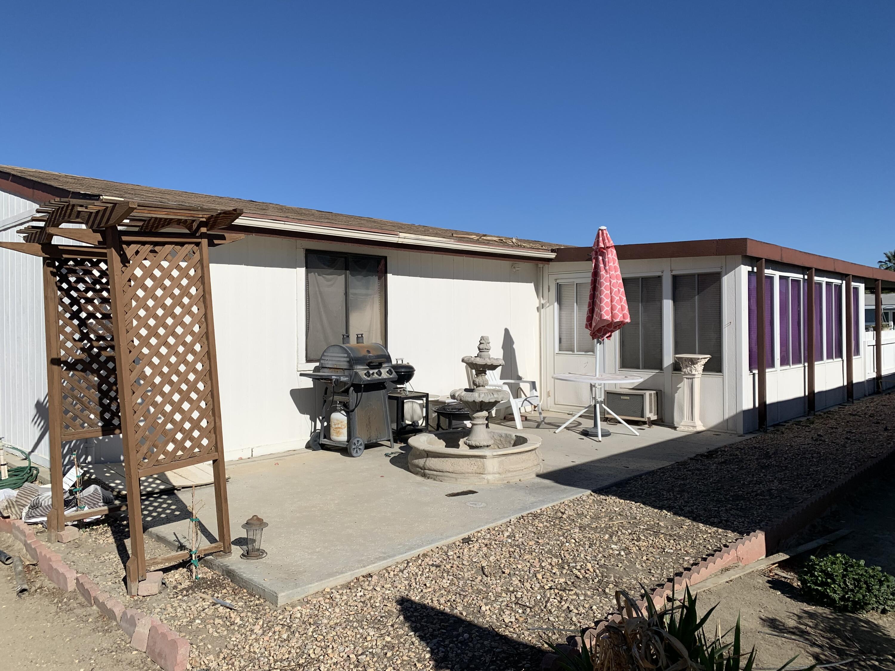 47685 Prado Way Indio, CA 92201 - Photo 24 of 26 a view of a patio with table and chairs and potted plants