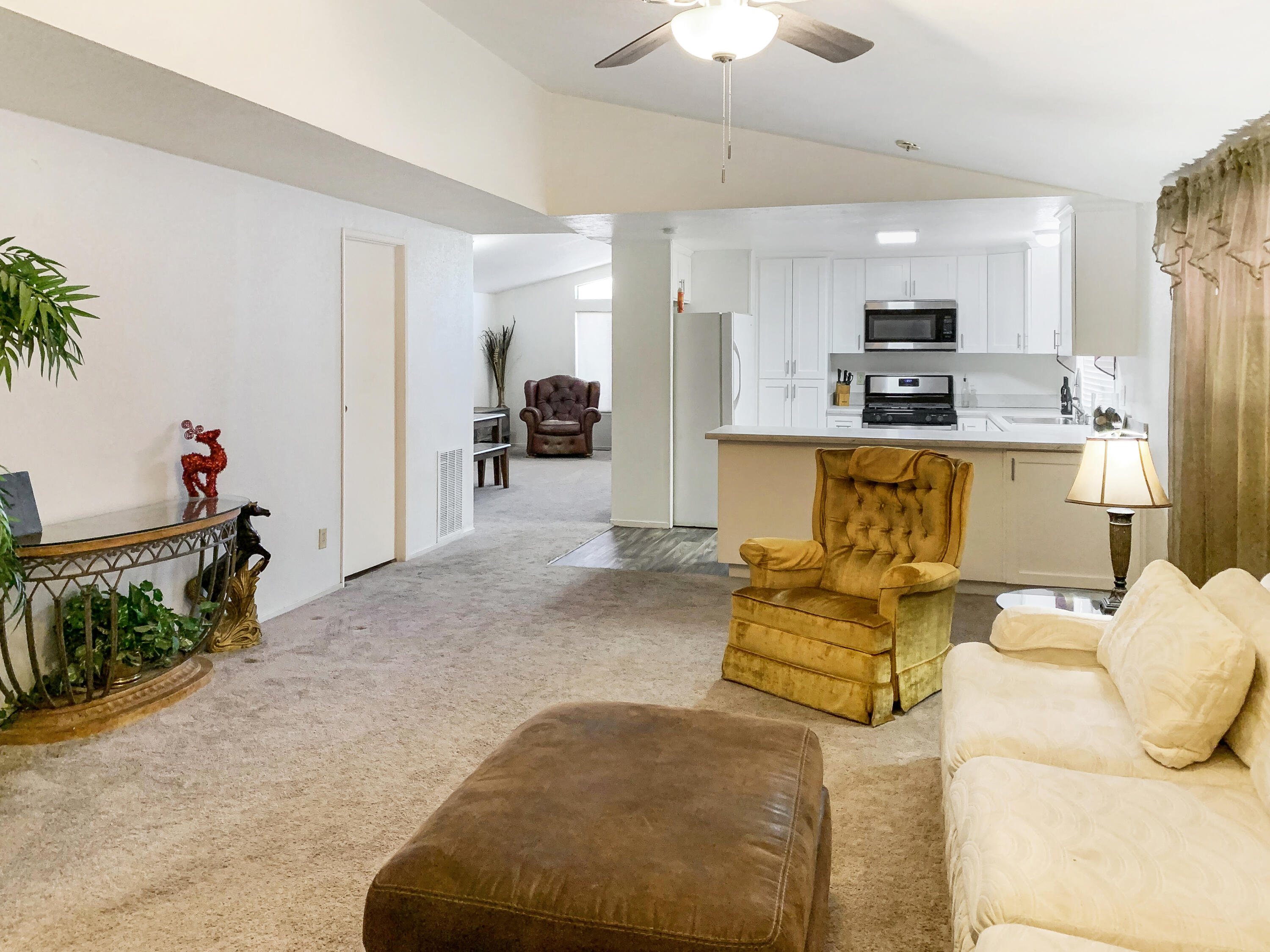 47685 Prado Way Indio, CA 92201 - Photo 8 of 26 a living room with furniture kitchen view and a chandelier