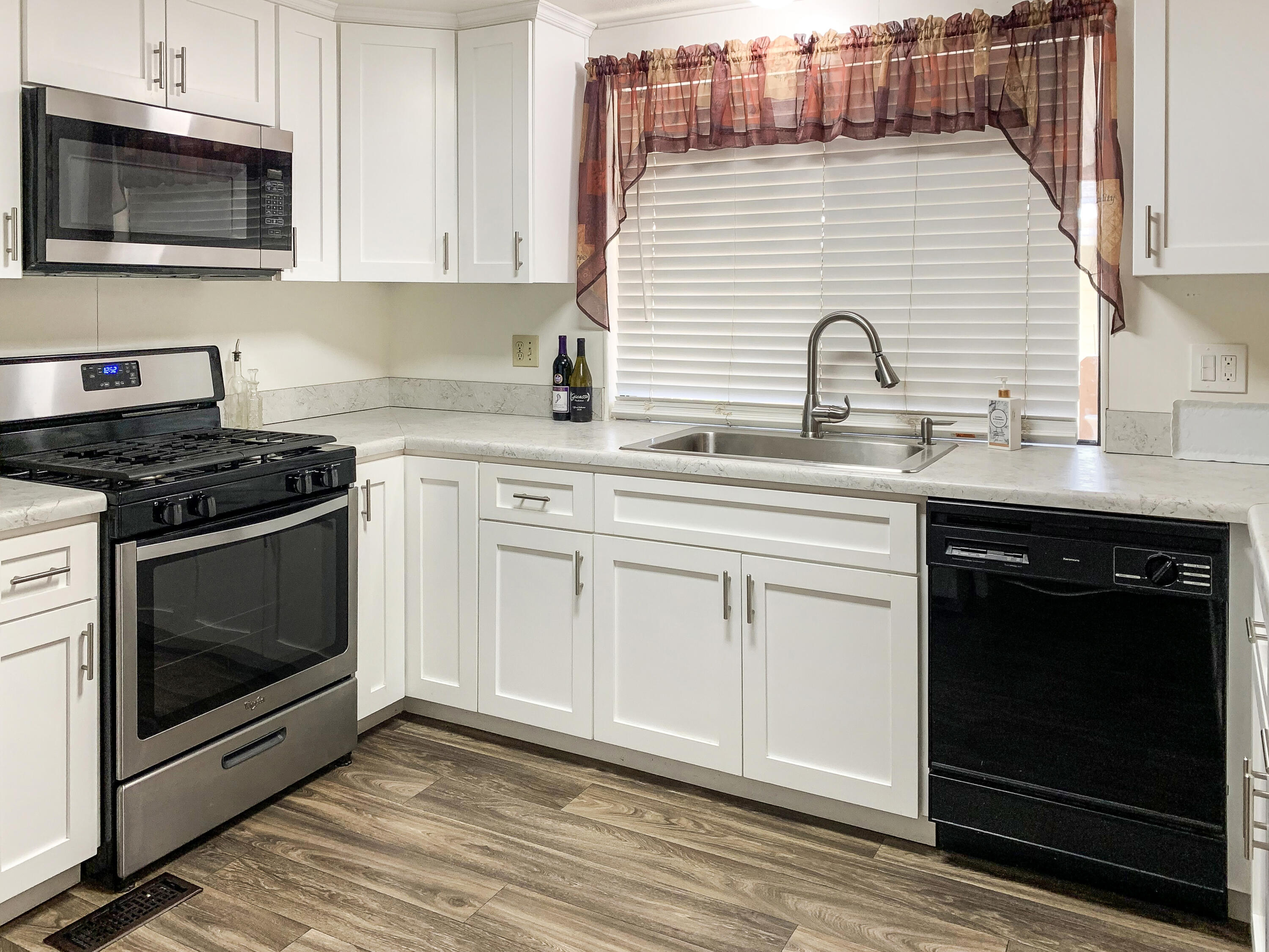 47685 Prado Way Indio, CA 92201 - Photo 10 of 26 a kitchen with granite countertop white cabinets stainless steel appliances and sink