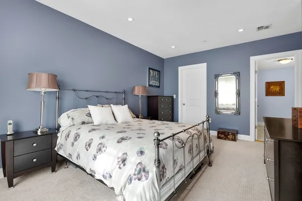 a bedroom with a bed and a lamp