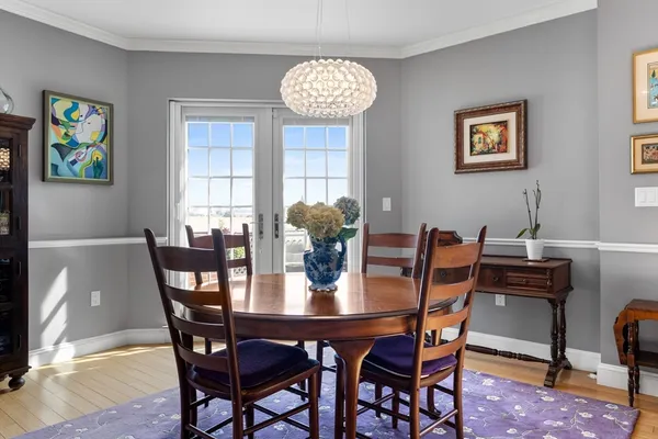 a view of a dining room with furniture and chandelier