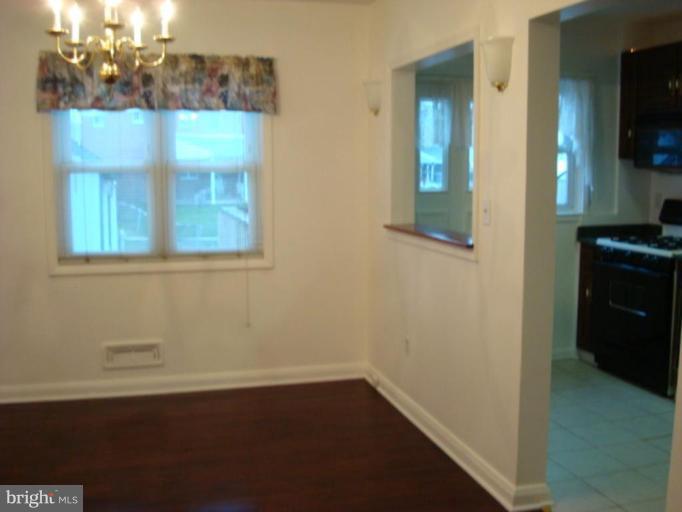 8013 Kimberly Road Dundalk, MD 21222 - Photo 3 of 12 wooden floor in an empty room
