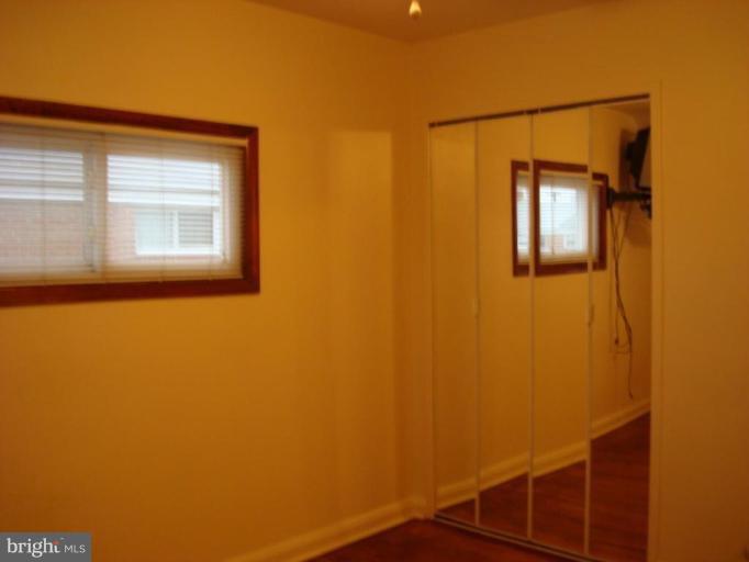 8013 Kimberly Road Dundalk, MD 21222 - Photo 8 of 12 a view of a small space with wooden floor and a window