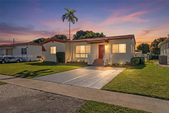 a house view with a sitting space and garden