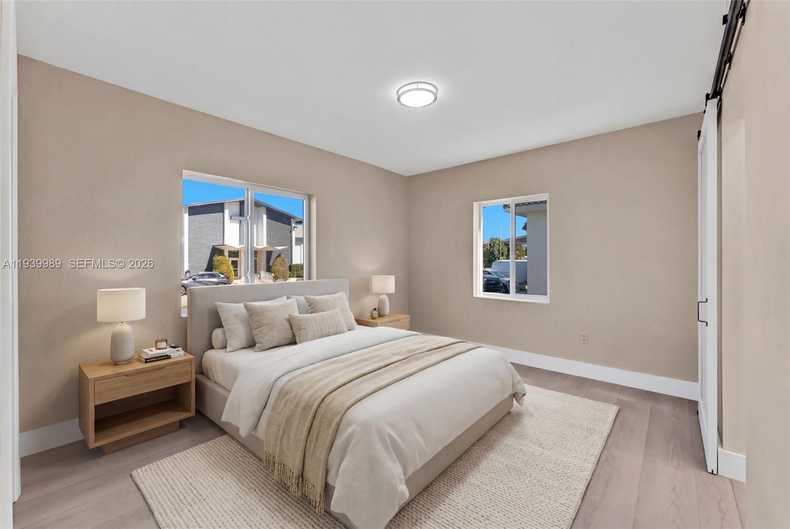 40 West 58th Street Hialeah, FL 33012 - Photo 13 of 25 a bedroom with a bed and a night stand