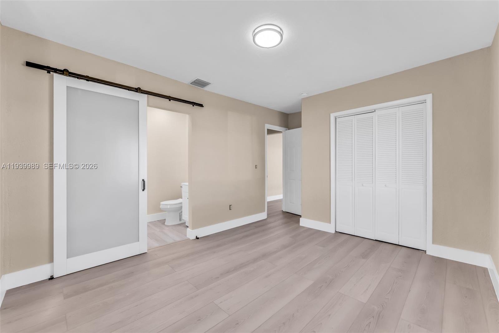 40 West 58th Street Hialeah, FL 33012 - Photo 15 of 25 an empty room with wooden floor and a window