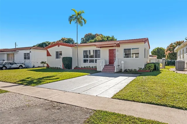 a view of house with outdoor space and swimming pool