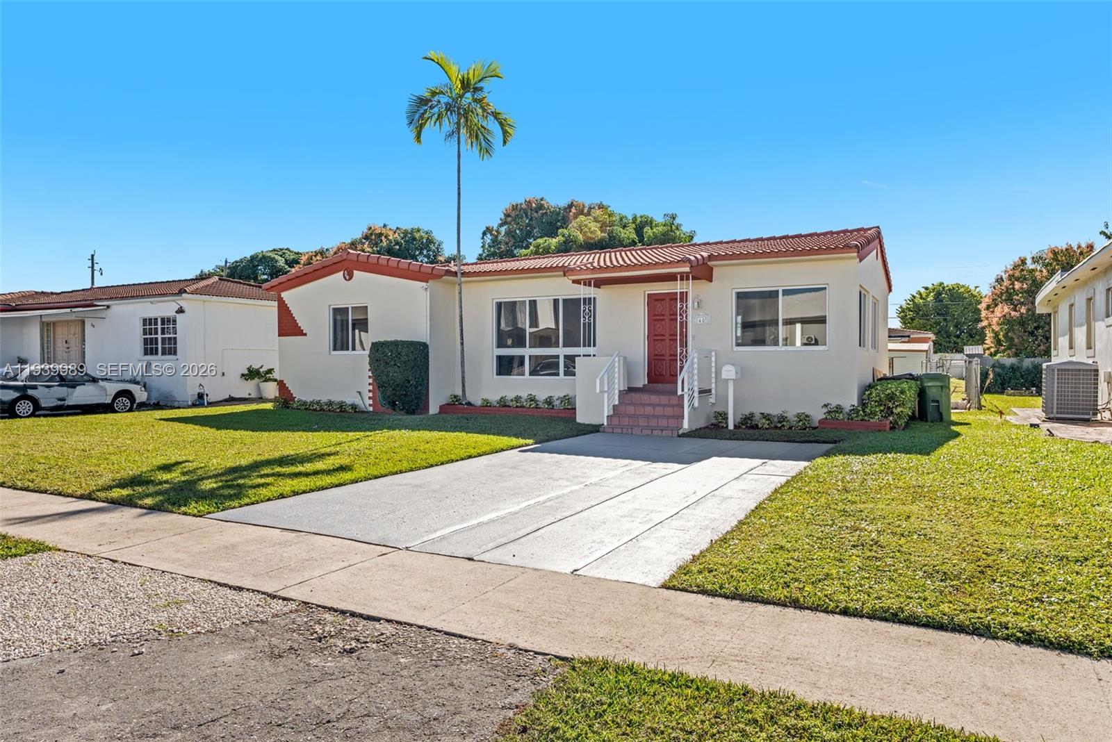40 West 58th Street Hialeah, FL 33012 - Photo 2 of 25 a view of house with outdoor space and swimming pool