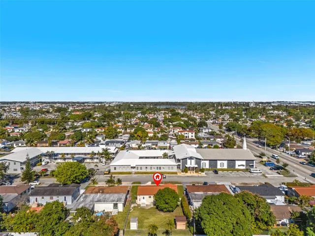 an aerial view of residential building and ocean