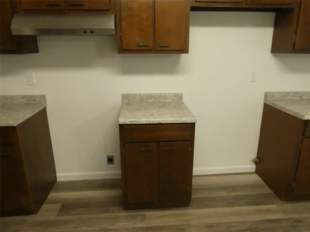 a room with wooden floor and a sink