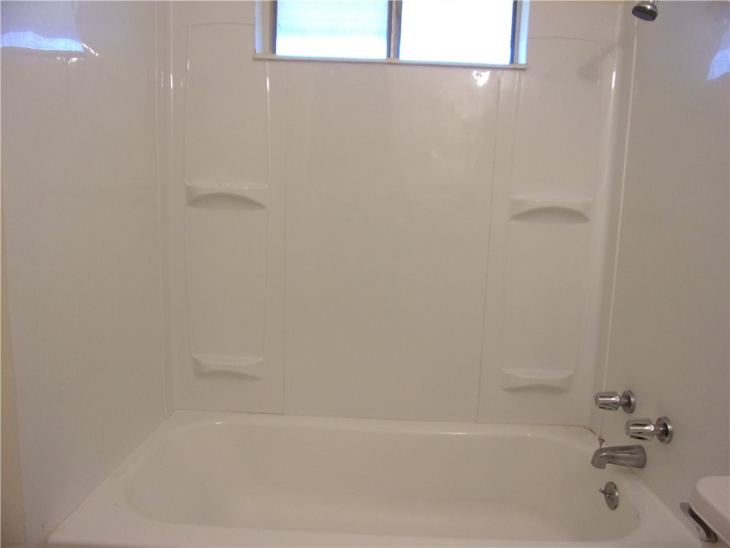 3034 Sunnybrook Road Corpus Christi, TX 78415 - Photo 13 of 20 a bathroom with a bathtub