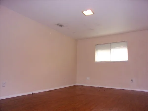 an empty room with a empty space and windows