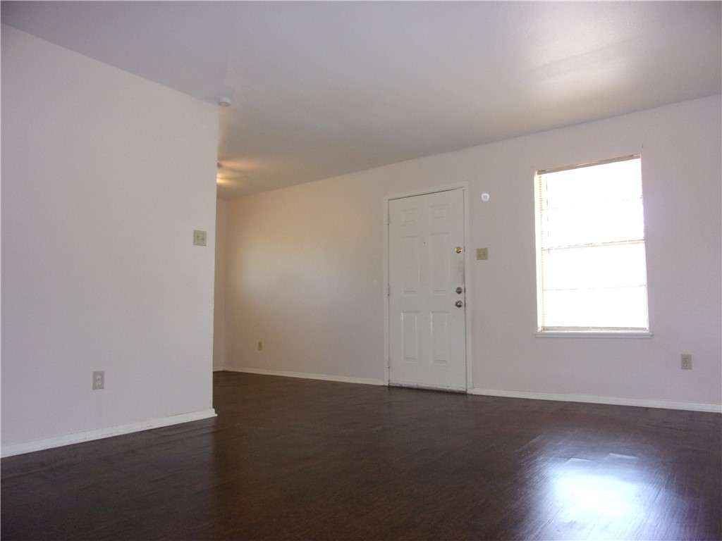 3034 Sunnybrook Road Corpus Christi, TX 78415 - Photo 3 of 20 an empty room with wooden floor and windows
