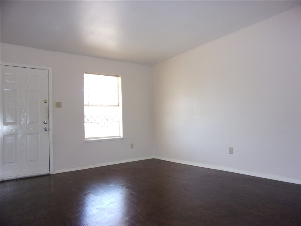 3034 Sunnybrook Road Corpus Christi, TX 78415 - Photo 4 of 20 an empty room with wooden floor and windows