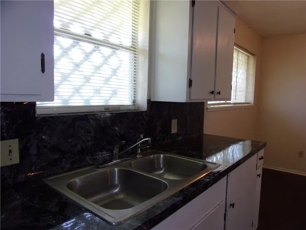 a kitchen that has a sink and a window