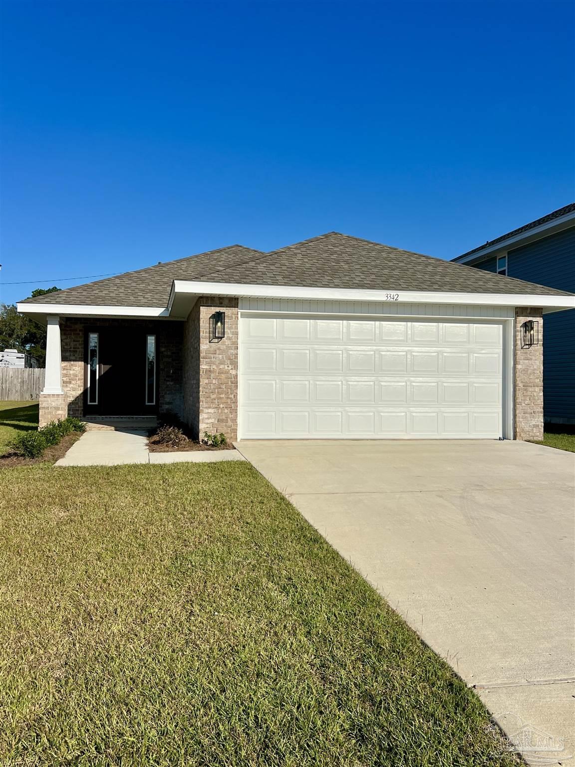 3327 Bliss Lane, Unit 12E Cantonment, FL 32533 - Photo 1 of 15 a front view of a house with a yard