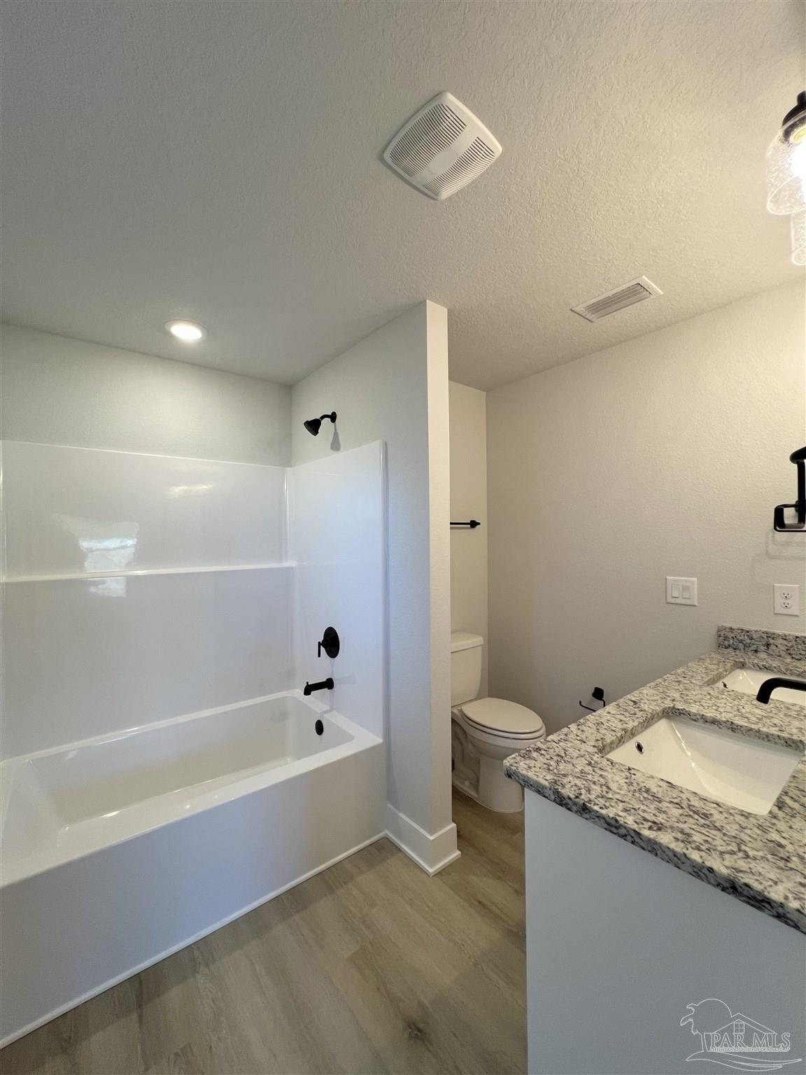 3327 Bliss Lane, Unit 12E Cantonment, FL 32533 - Photo 12 of 15 a bathroom with a granite countertop sink a toilet and shower