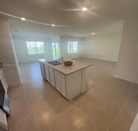 a kitchen with stainless steel appliances granite countertop a sink and a stove