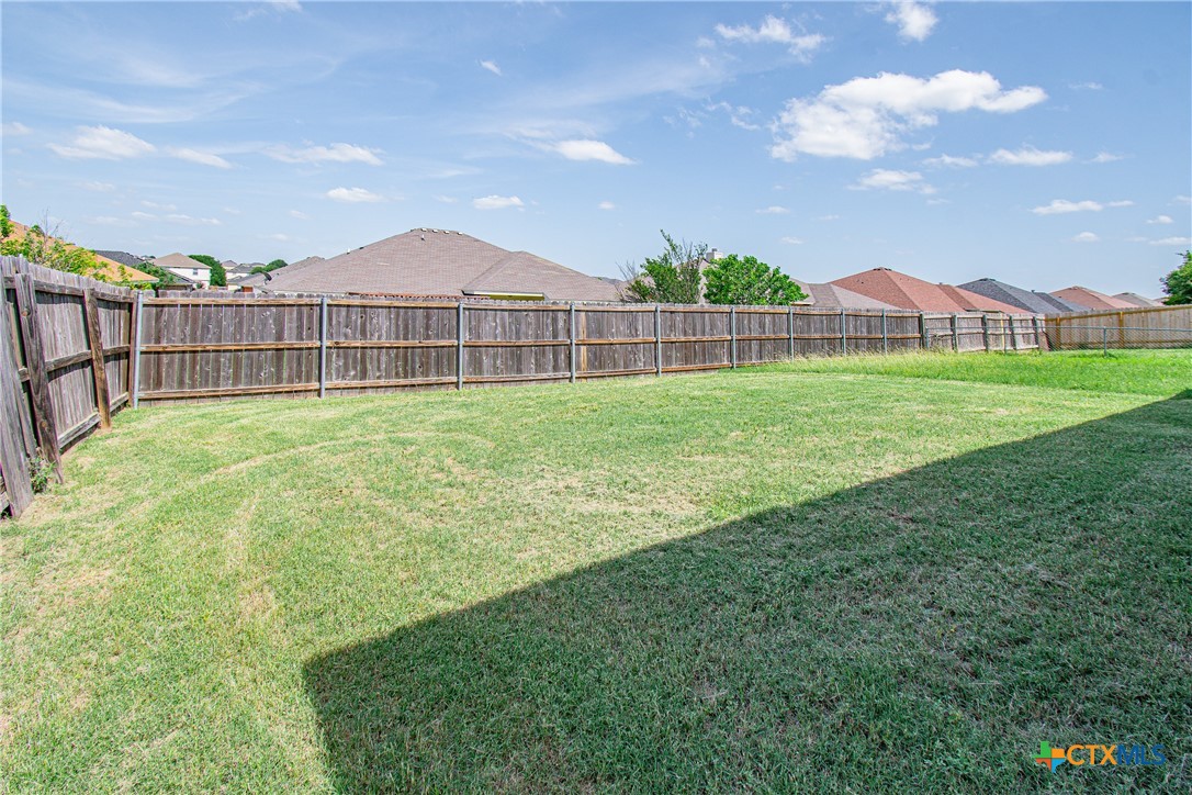 6509 Temora Loop, Unit A Killeen, TX 76549 - Photo 19 of 19 a view of a house with a yard and fence