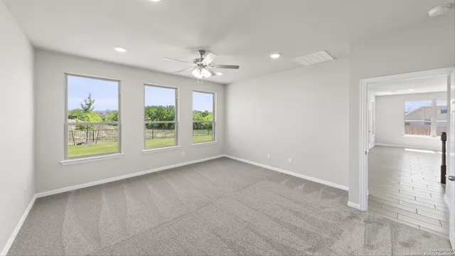 an empty room with fan and a ceiling fan