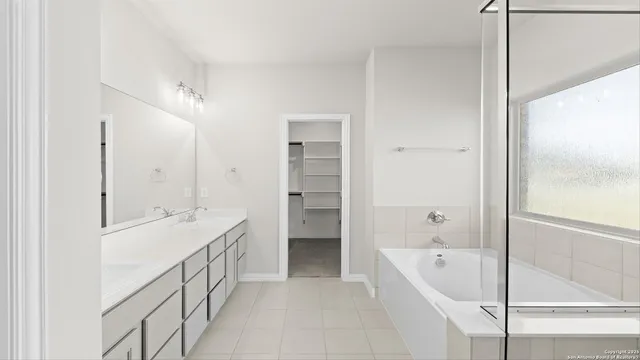 a bathroom with a double vanity sink and mirror