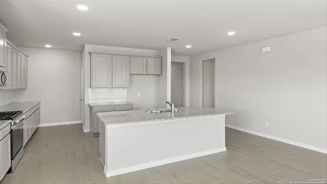 a view of kitchen with wooden floor and electronic appliances