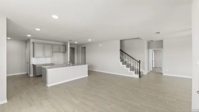 a kitchen with stainless steel appliances granite countertop a stove top oven sink and cabinets