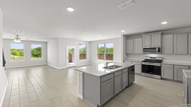 a view of a kitchen with a stove cabinets and a kitchen