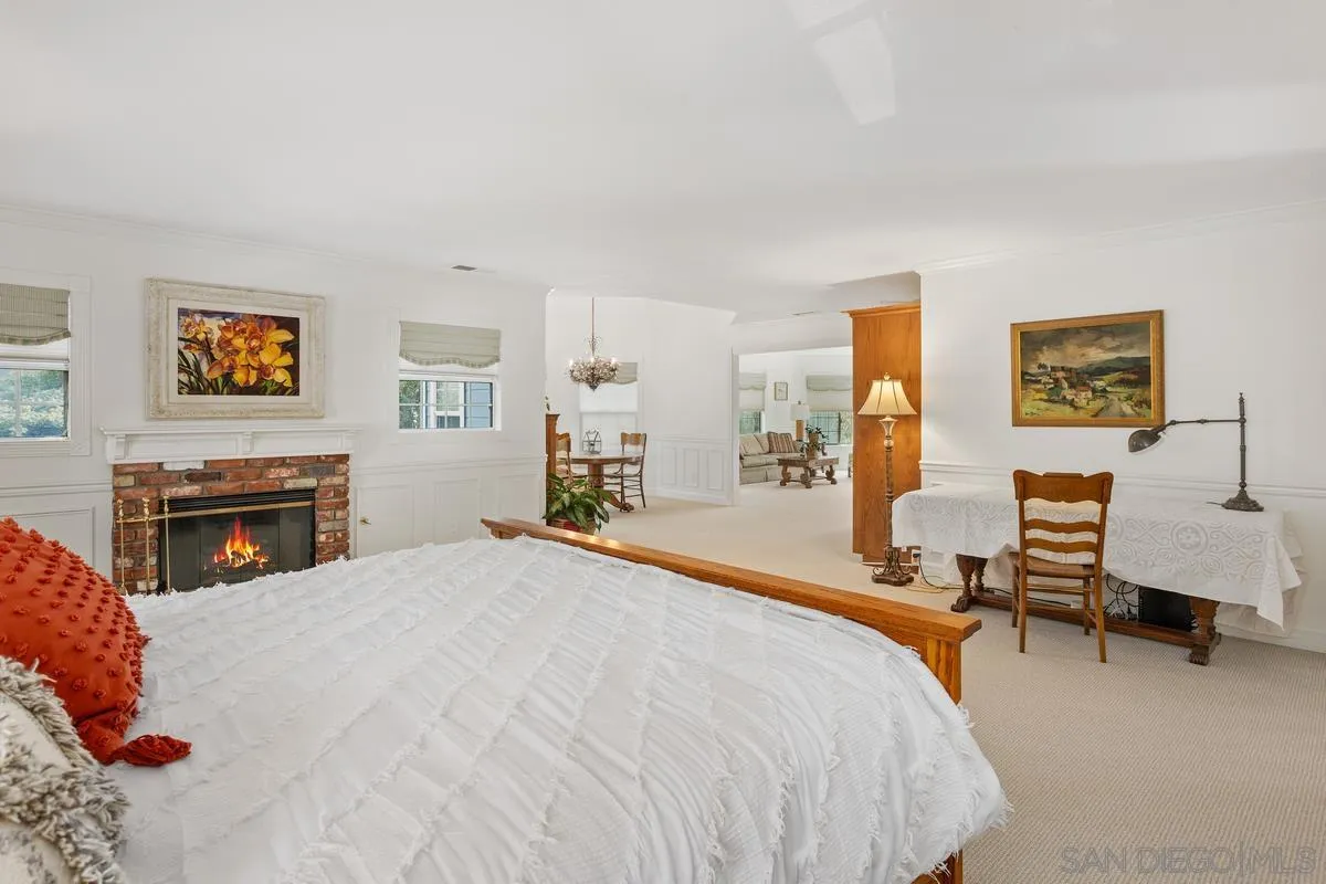 1642 Kings Way Vista, CA 92084 - Photo 19 of 41 a spacious bedroom with a bed a table and chair in it