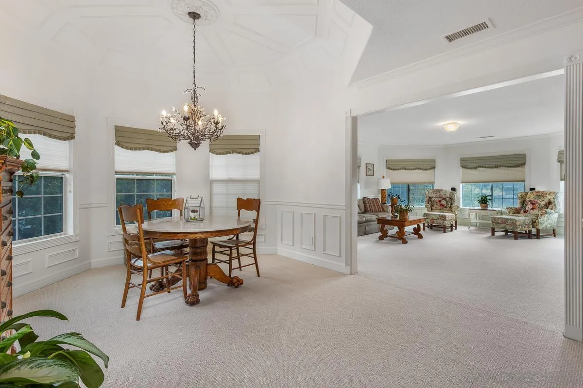 1642 Kings Way Vista, CA 92084 - Photo 24 of 41 a view of a dining room and livingroom with furniture wooden floor a chandelier