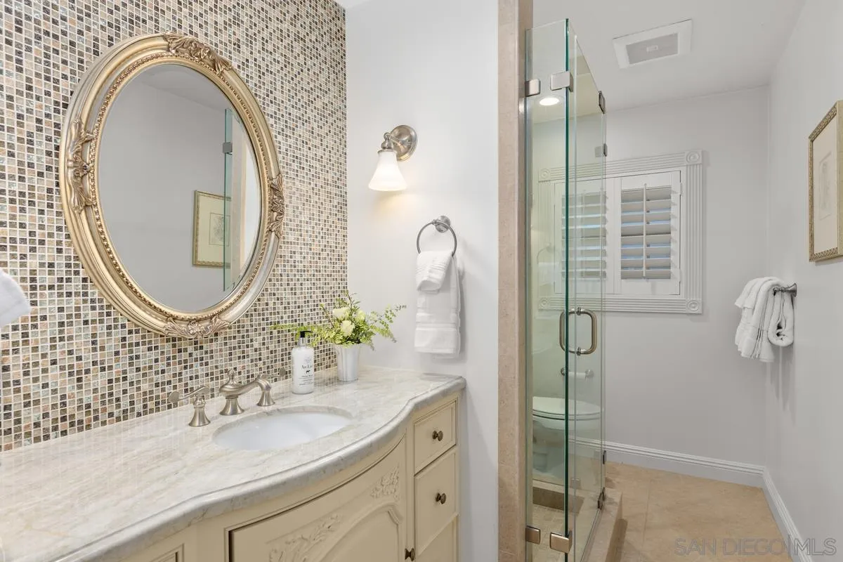 1642 Kings Way Vista, CA 92084 - Photo 32 of 41 a bathroom with a granite countertop double vanity sink and a mirror