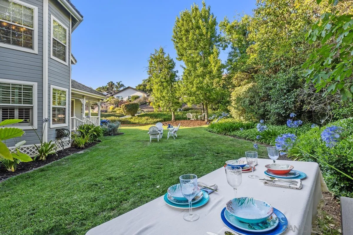 1642 Kings Way Vista, CA 92084 - Photo 33 of 41 a view of a table and chairs in back yard of the house