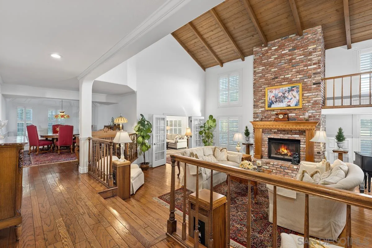 1642 Kings Way Vista, CA 92084 - Photo 7 of 41 a living room with furniture a fireplace and wooden floor