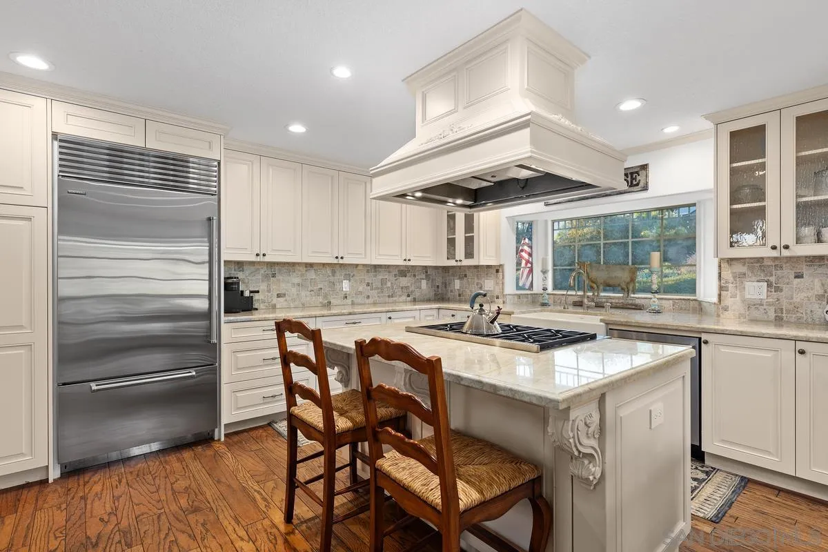 1642 Kings Way Vista, CA 92084 - Photo 8 of 41 a kitchen with a sink cabinets and wooden floor