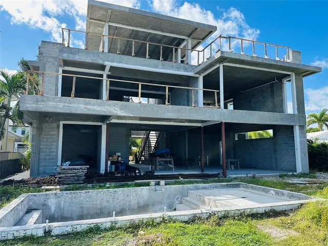 a view of a brick house with large windows and a yard