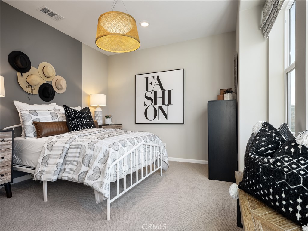 7176 Squall Drive Riverside, CA 92503 - Photo 12 of 15 a bedroom with a bed and a painting on the wall