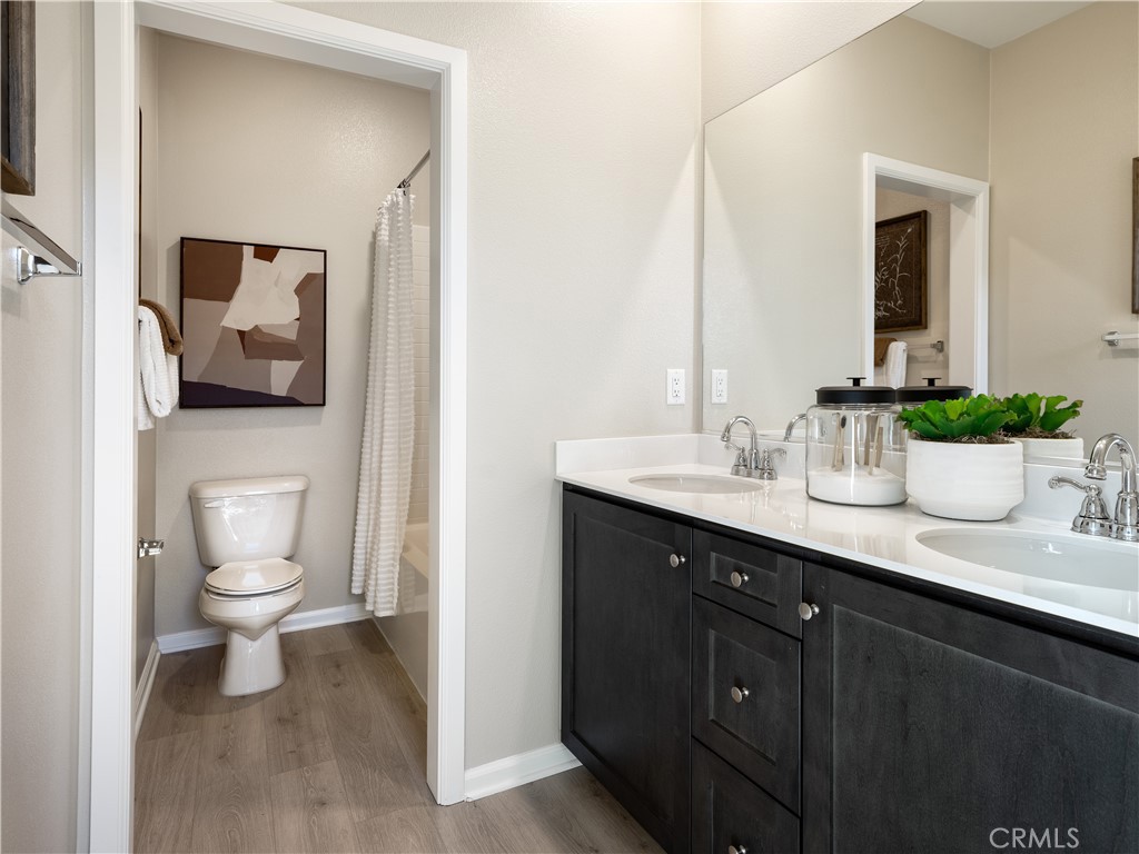 7176 Squall Drive Riverside, CA 92503 - Photo 13 of 15 a bathroom with a toilet sink and mirror