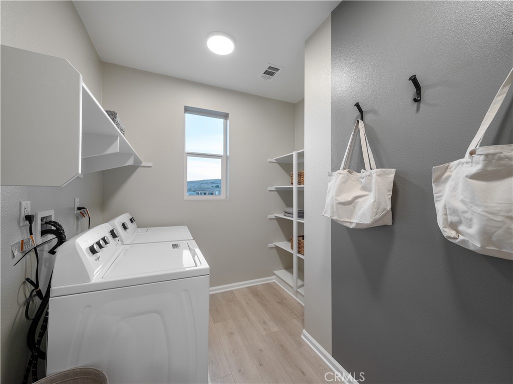 7176 Squall Drive Riverside, CA 92503 - Photo 14 of 15 a utility room with dryer and washer