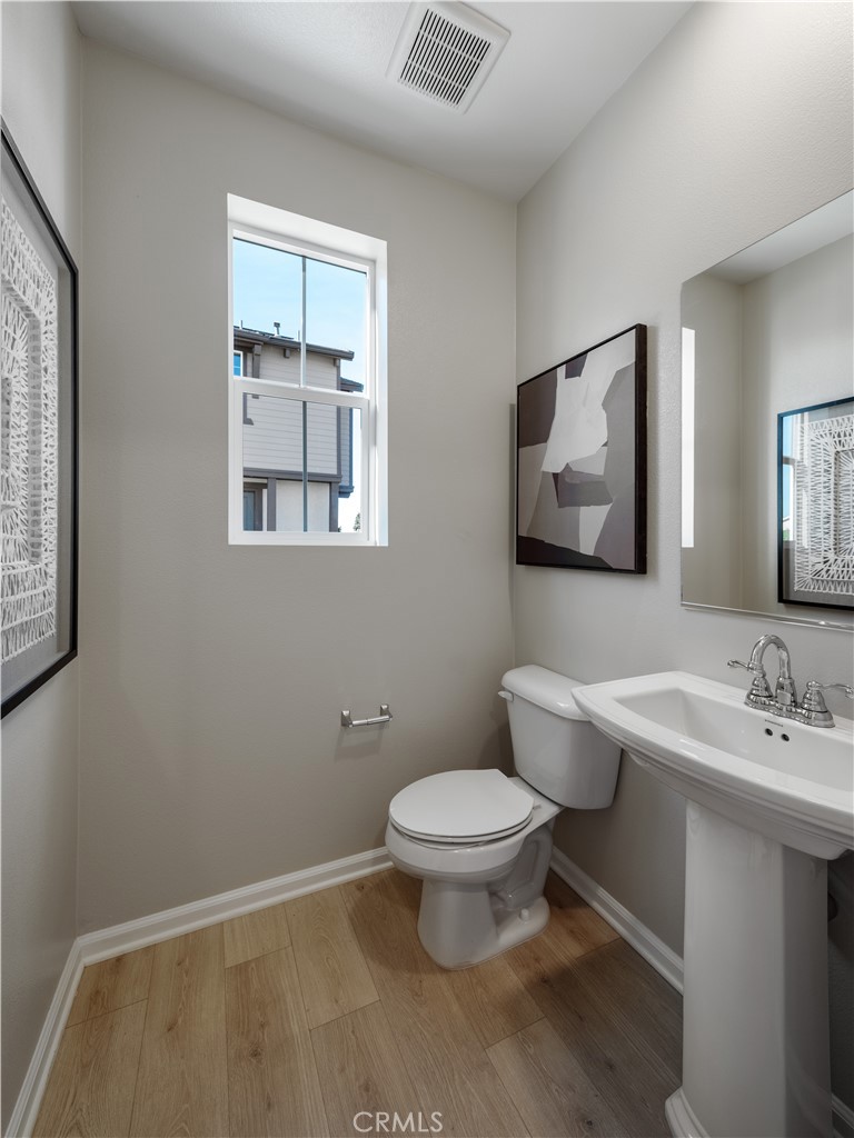 7176 Squall Drive Riverside, CA 92503 - Photo 15 of 15 a bathroom with a toilet sink and mirror